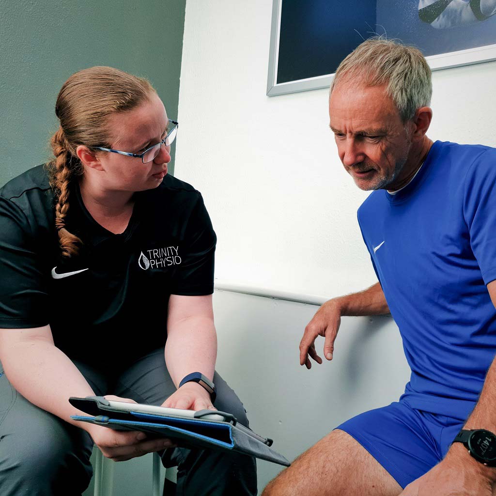 Trinity physiotherapist explaining assessment findings to a patient