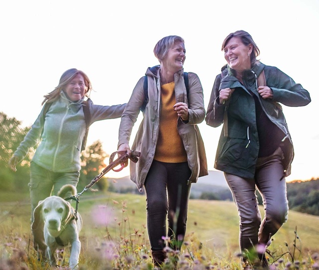 Friends walking outdoors together, active and smiling