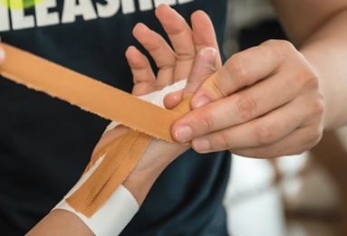 Physiotherapist discussing a wrist and hand assessment with a patient